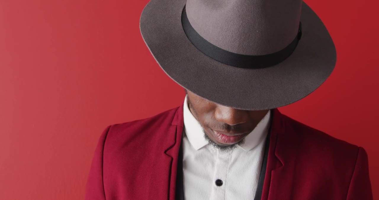Man with red suit and a hat, by Norma Mortenson, on Pexels